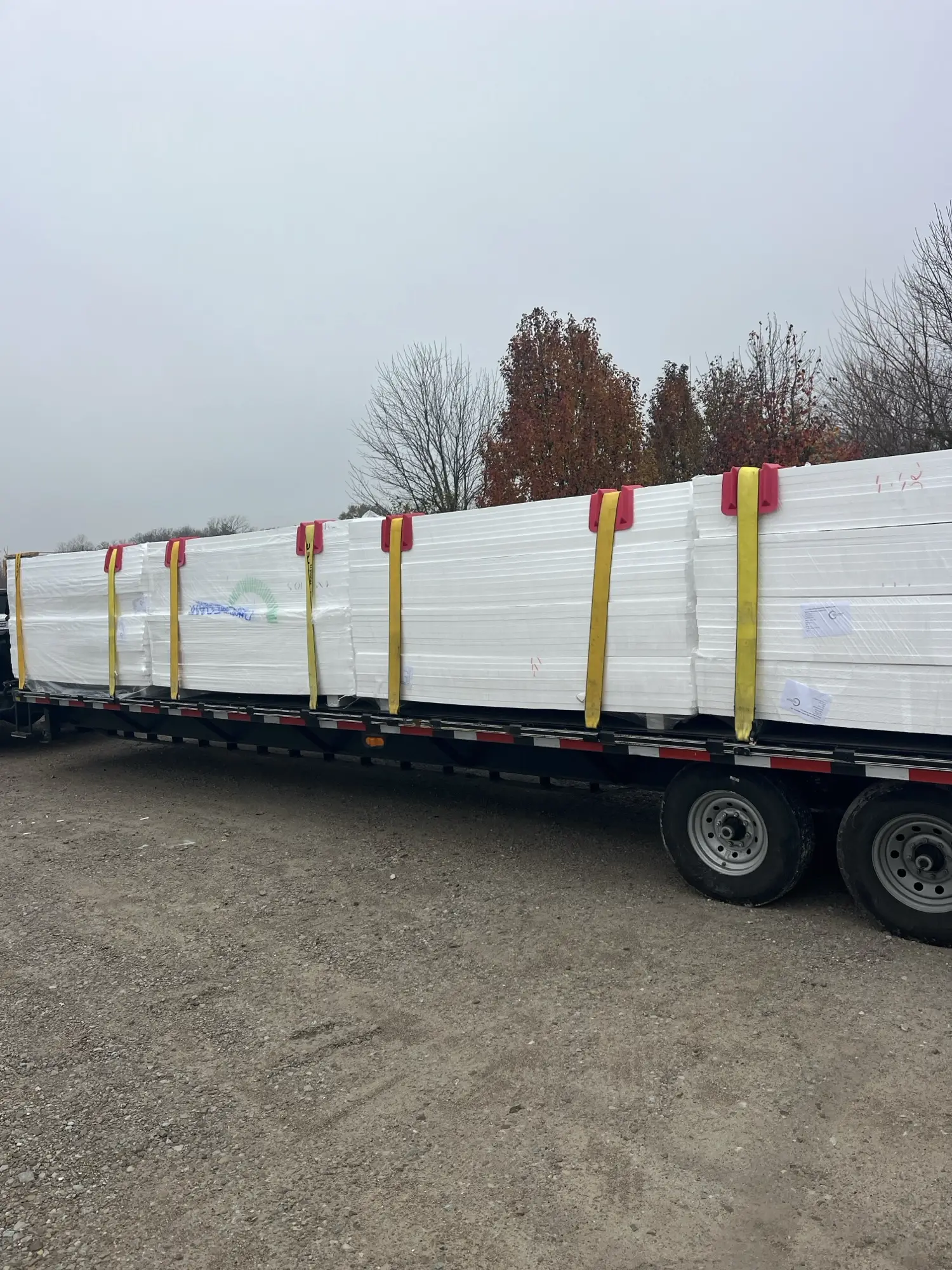 Flatbed trailer with EPS foam bundles strapped down for delivery