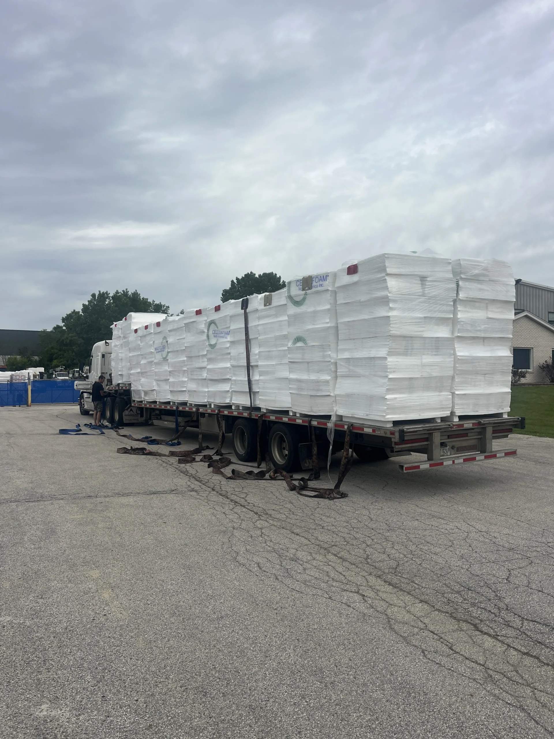 Flatbed truck carrying bundles of EPS foam for delivery