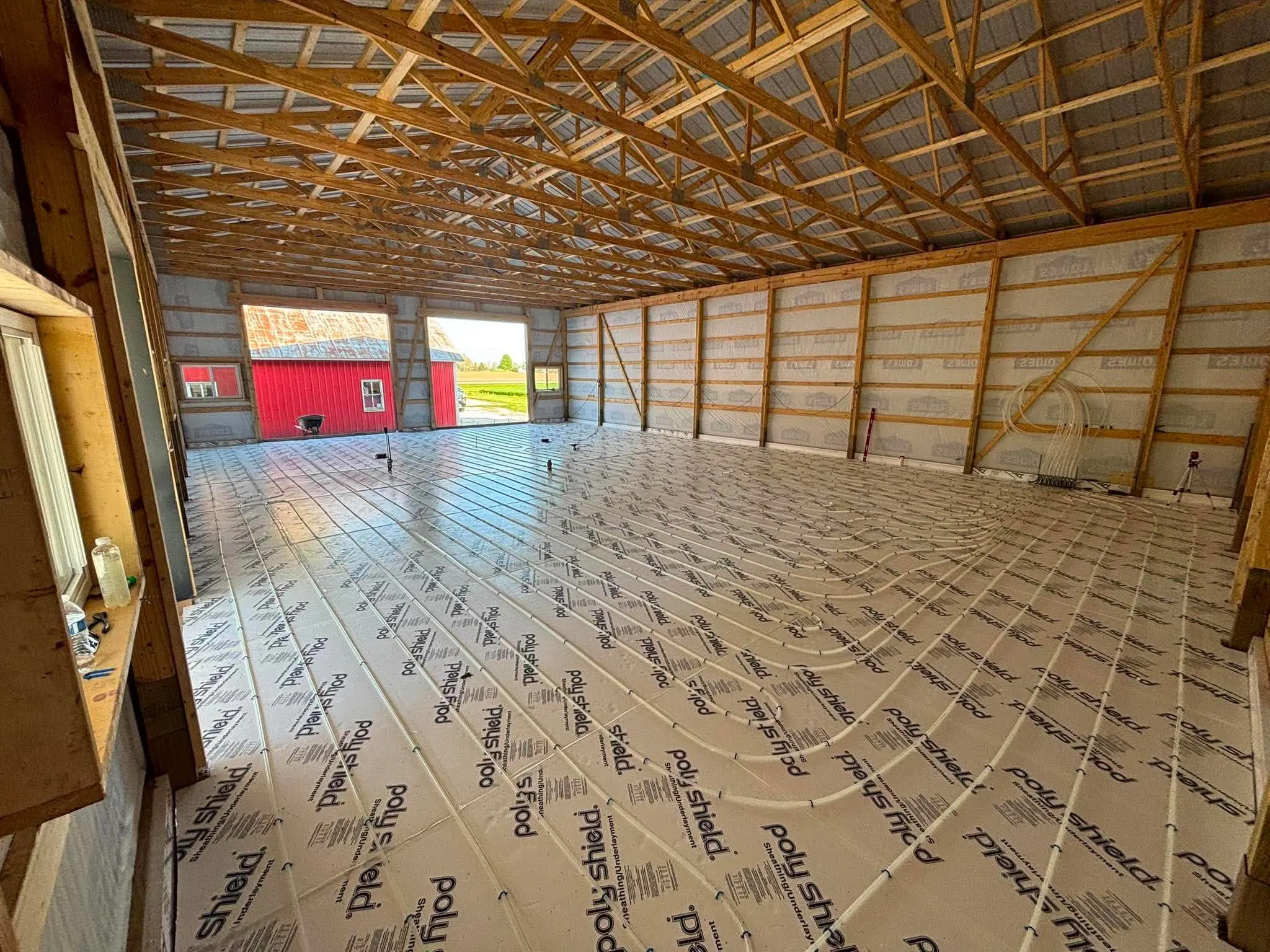 Pole barn floor covered in PolyShield-faced EPS insulation before the slab pour