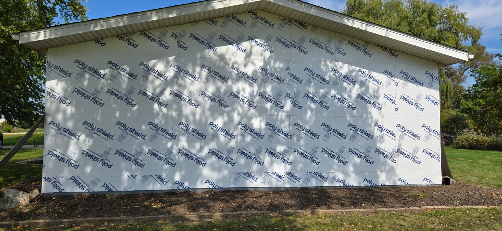 Exterior wall of an outbuilding covered in Poly Shield sheathing/underlayment panels